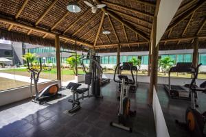 a gym with cardio equipment in a building at Cambuci Hotel in Camaçari