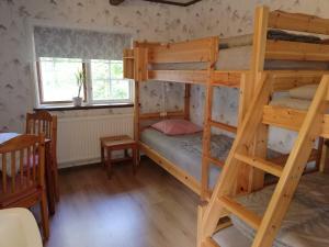 a room with two bunk beds in a house at STF Långasjö Vandrarhem in Långasjö