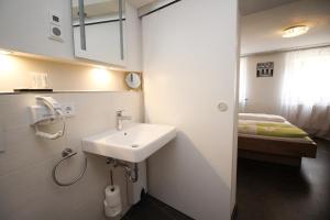 a small bathroom with a sink and a bed at Ferienwohnung am Griesgarten in Bamberg +44 photos