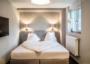 Postel nebo postele na pokoji v ubytování Landcafe mit Mini Hotel