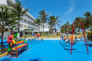 a pool at the resort with people on the slides at Hotel El Dorado in San Andrés