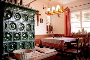 a room with a table and a large wall of plates at Haus Poxleitner in Mauth