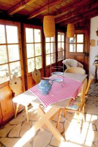 a dining room with a table and chairs and windows at Haus Poxleitner in Mauth