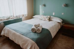 Una cama o camas en una habitación de Kospi Boutique Guesthouse