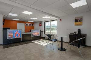 a waiting room with two chairs and two televisions at Motel 6-White, GA - Cartersville in White