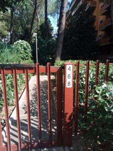 a red fence with a sign on it at MEL Affittacamere in Florence