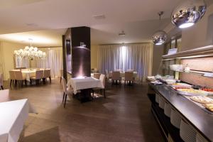 a kitchen with a dining room with tables and chairs at Hotel Parigi 2 & Spa in Dalmine