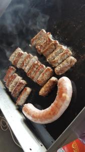 a group of sausages and sausage on a grill at Gastehaus Melcher in Villach