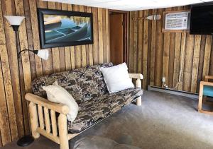 a living room with a couch and a tv at Shore Meadows Lodge LLC in Lake George