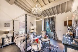 a bedroom with a bed and a chandelier at Sweet Tuscany in Arezzo