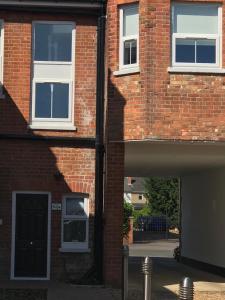 a brick building with a door and a window at Berkshire Serviced Apartment Helena 12 in Reading