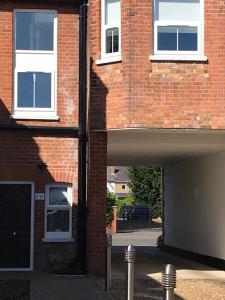 an entrance to a brick building with a garage at Berkshire Serviced Apartment Helena 12 in Reading
