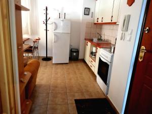 a kitchen with a white refrigerator and a table at Kalamata Downtown Apartment in Kalamata +20 photos