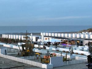a building with a playground in front of the ocean at Appartement Knokke-Heist in Knokke-Heist