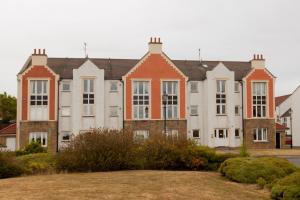 a large house with a yard in front of it at Prime Dalgety Bay Waterfront Apartment in Saint Davids