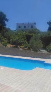 a swimming pool with a building in the background at Auberge Casa Linda in Chefchaouene