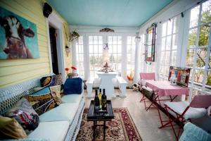 a living room with a couch and a table at The Stirling House Waterfront Inn Greenport in Greenport