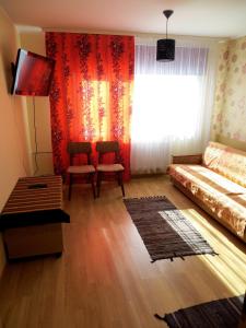 a living room with a bed and a window at Vao Guesthouse in Vao