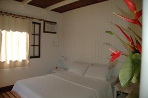 A bed or beds in a room at Casa do Canto