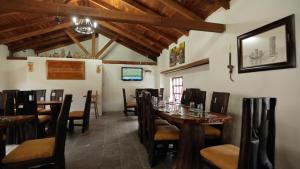 a dining room with wooden tables and chairs at Hosteria San Jose de Sigchos in Sigchos