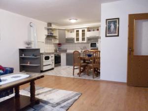 a kitchen and dining room with a table and chairs at Kuca za odmor Sarcevic in Prozor