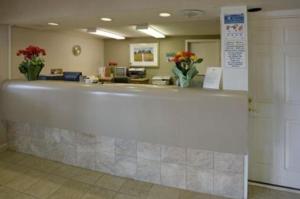 a lobby with a counter with flowers on it at Americas Best Value Inn & Suites in Murfreesboro in Murfreesboro