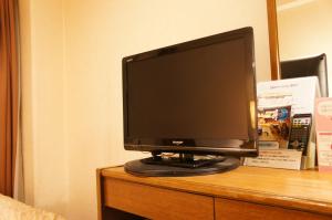 A television and/or entertainment centre at Hotel Sunroute Matsuyama