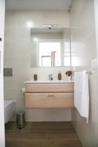 a bathroom with a sink and a mirror at Apartamentos Balcón de Nerja - Adults Only in Nerja