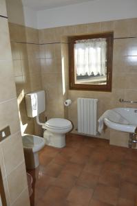 a bathroom with a toilet and a sink at Valdigiust in Campodolcino