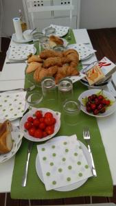 a table with plates of food and tomatoes on it at Bed And Breakfast T57 in Bitonto