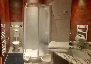 a bathroom with a shower and a toilet and a sink at Guest House Santiago in Arco +34 photos