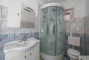 a bathroom with a shower and a sink and a toilet at Apartman Angelina in Supetar +8 photos