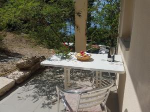 a table and chair with a bowl of fruit on it at Villa Luka in Brela