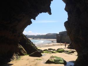 a view of a beach from a cave at Palace Surf Lodge in Newquay