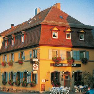 a large building with a restaurant in front of it at Hotel Gasthof zur Linde in Rothenburg ob der Tauber