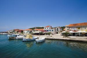 a group of boats are docked in a harbor at Apartment Komoda in Kaprije