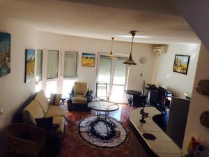 a living room with a couch and a table at Holiday Home Mikki in Dobra Voda