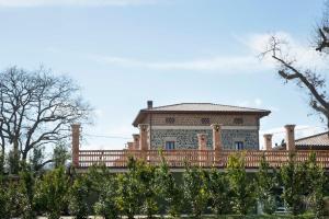 a large house with a fence in front of it at La Tenuta di Trimalcione in Pofi