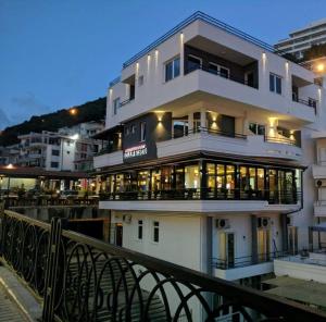 a large white building with many windows on a bridge at Bella Vista B&B in Ulcinj