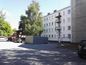 a parking lot in front of a large building at Anna Apartment in Pori