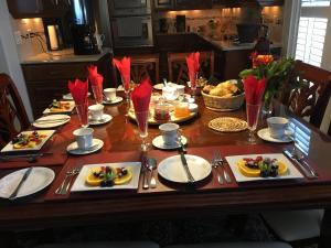 a wooden table with plates of food on it at Graystone Bed & Breakfast in Niagara-on-the-Lake