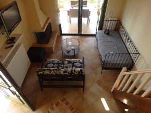 a living room with a couch and a tv at Villa G.Anagnostopoulos in Agios Andreas Ilias