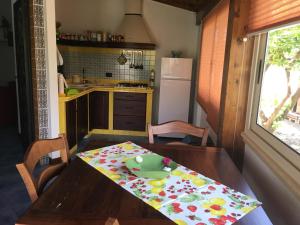 a kitchen with a wooden table with a green toy on it at Villa dei Limoni sul Mare in Castellammare del Golfo