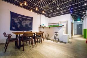 a room with a table and chairs and a counter at Central Woods in Yilan City