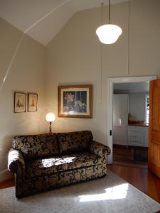 a living room with a couch and a lamp at The Chapel Deloraine in Deloraine