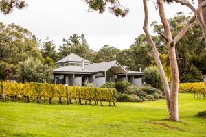a house with a green lawn in front of a house at Polperro Villas in Red Hill