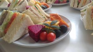 a plate of sandwiches and vegetables on a table at 甘丹民宿-三義火車站前 in Sanyi