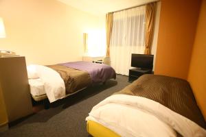 Postel nebo postele na pokoji v ubytování Hotel 1-2-3 Maebashi Mercury + 18 fotografií