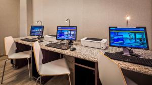 a room with three computers on a desk with chairs at Hotel Pentagon in Arlington