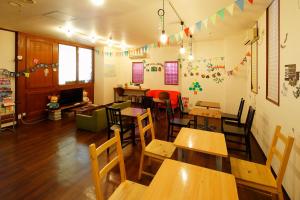 a classroom with wooden tables and chairs in a classroom at Business Hotel Taiyo in Osaka